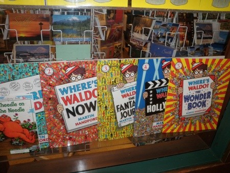 A collection of Where's Waldo books in a storefront window. These make great childrens' gifts.