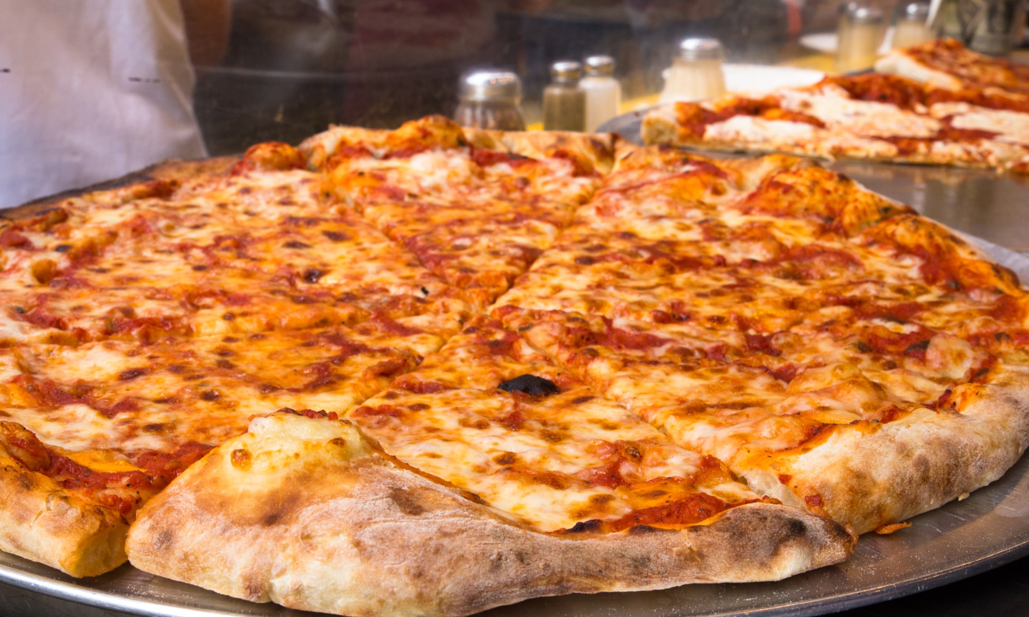 New York Style Pizza in Seattle resting on platter ready to be searved up