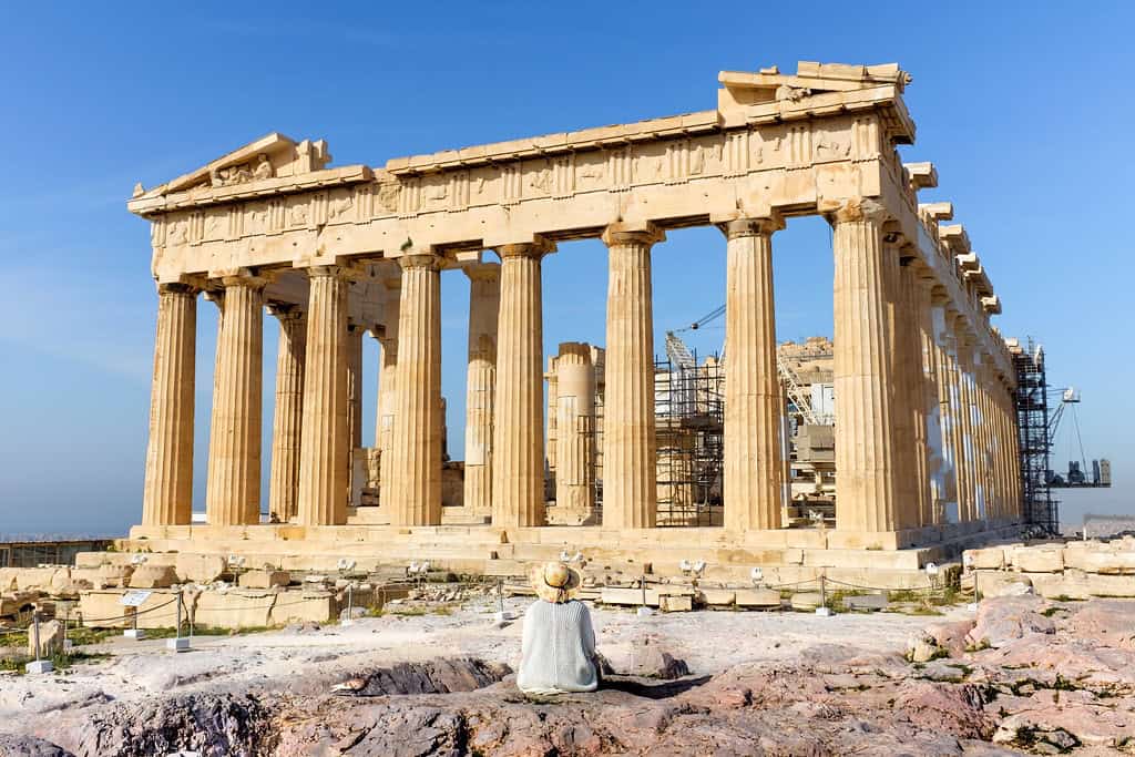 Lady sitting in front of Parthenon on Acropolis, Athens, Greece