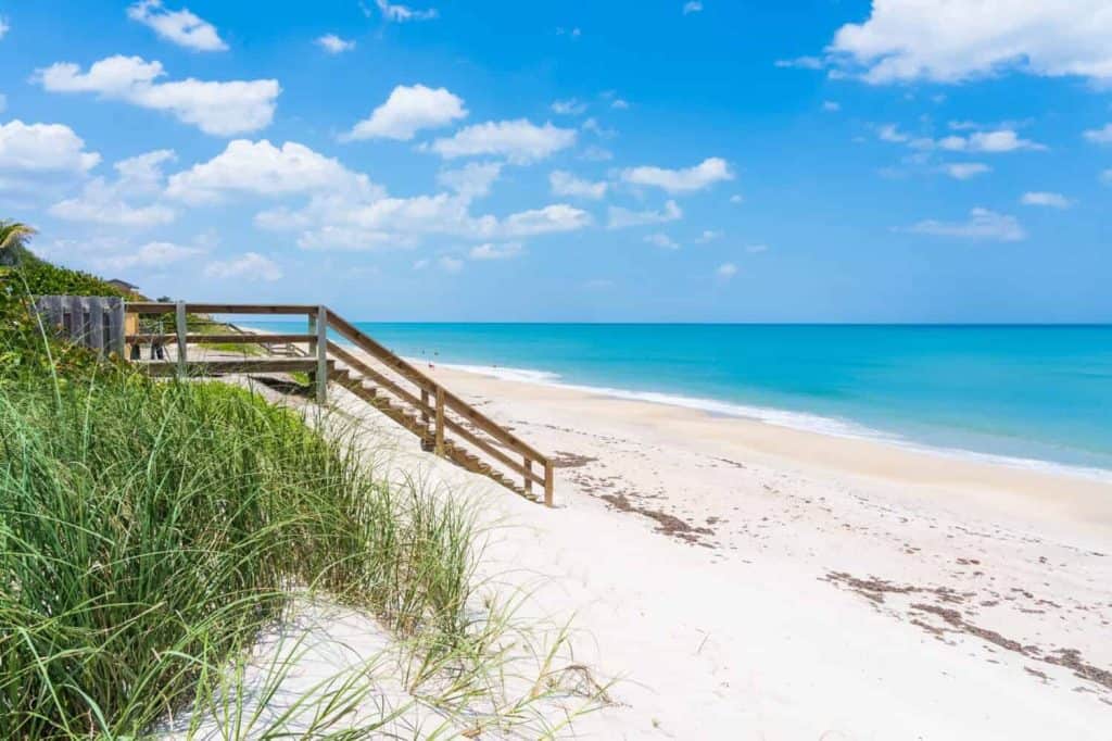 Wooden stairs to the beach by the ocean from a private home in Florida, Melbourne Beach. Typical beach view in Florida