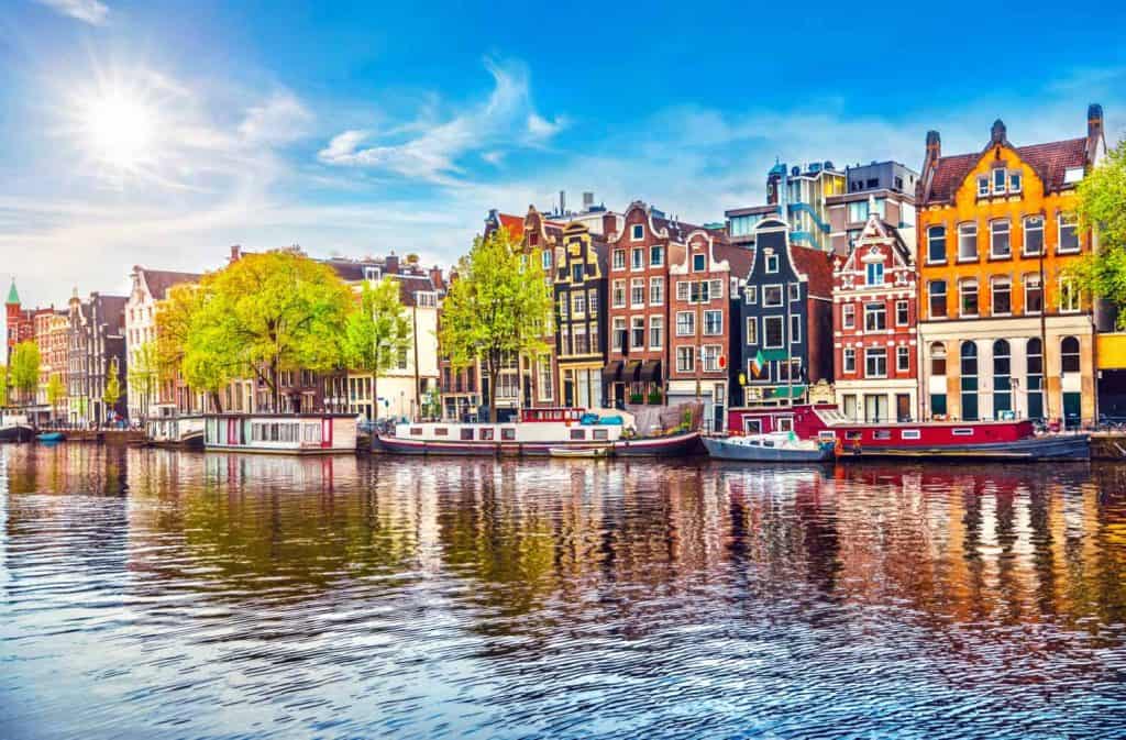 Amsterdam Netherlands dancing houses over river Amstel landmark in old european city spring landscape.