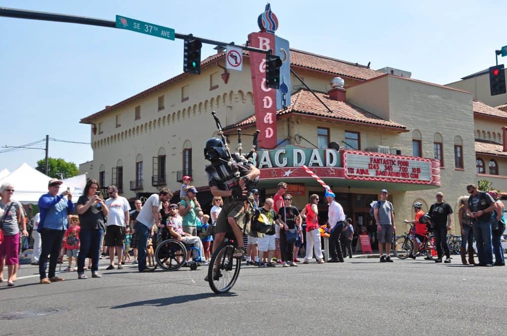 The Unipiper entertaining a crowd gathered in front of the Bagdad Theater in Portland, Oregon