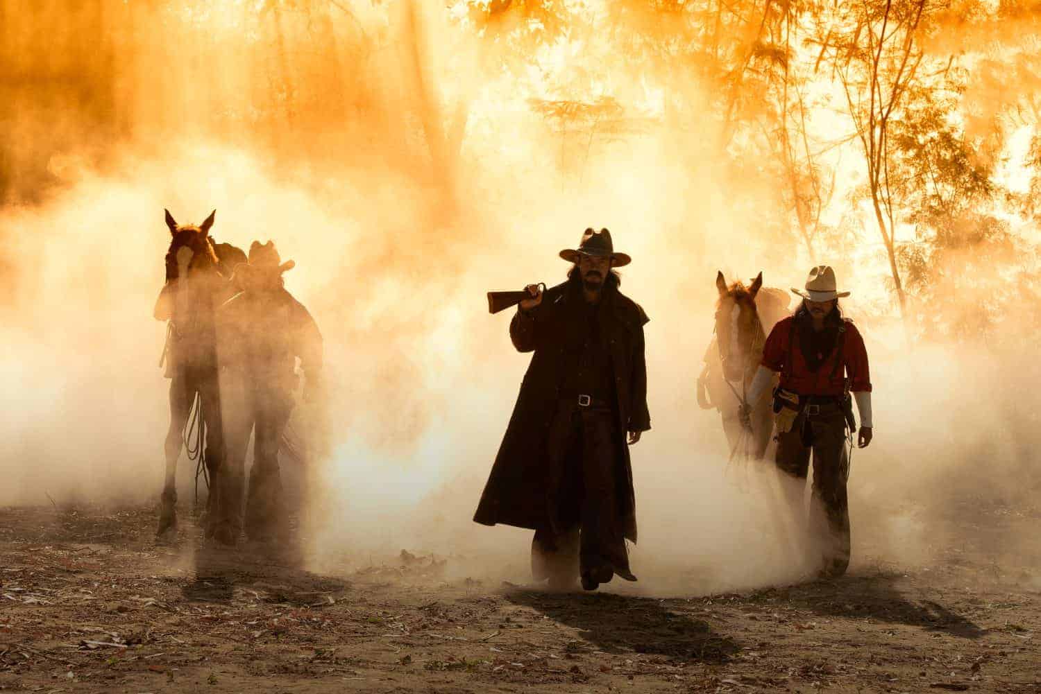 Portrait western cowboys riding horses, roping wild horses in Mexico and America.Smoke background.