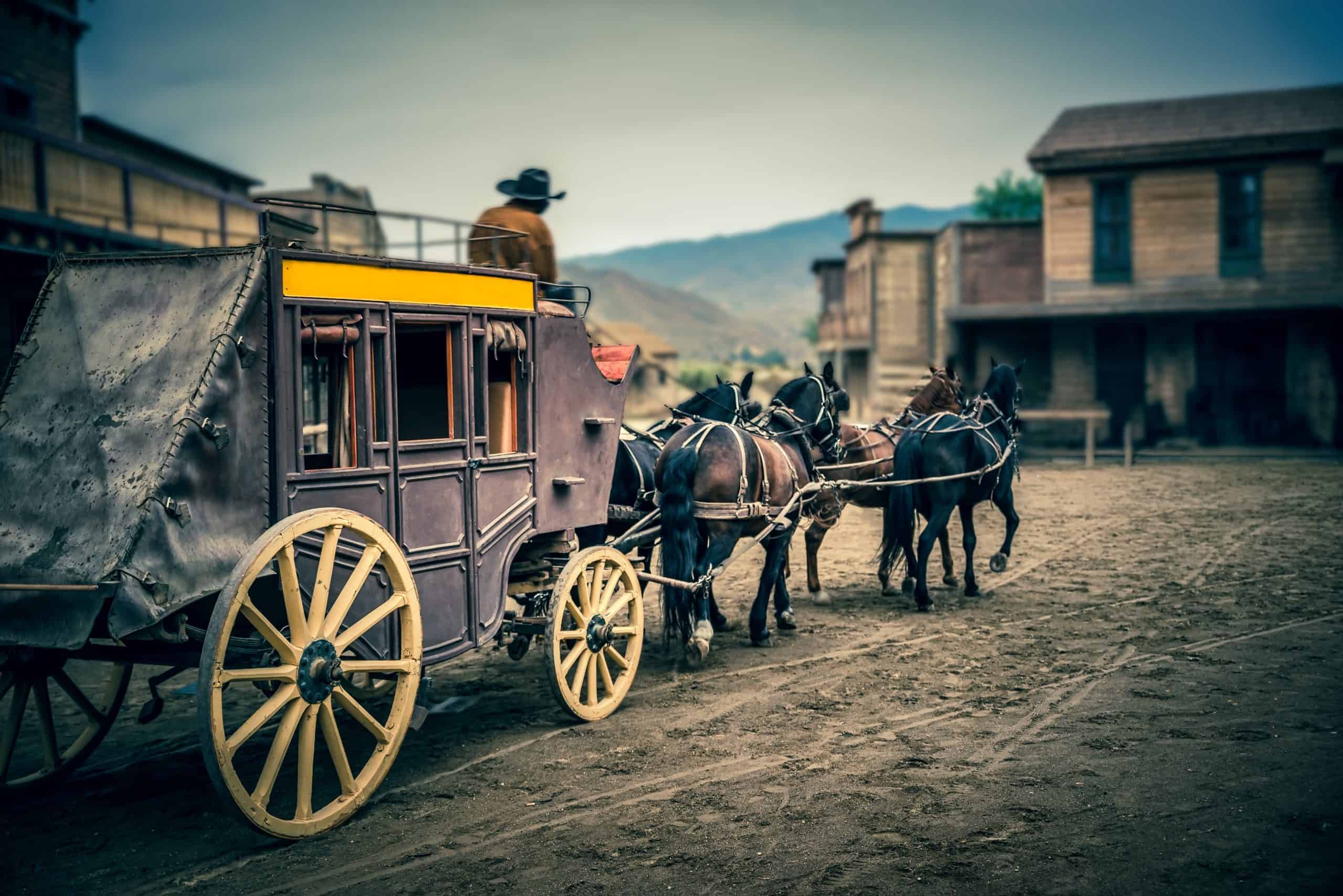 Stagecoach enters town square in American old wild West