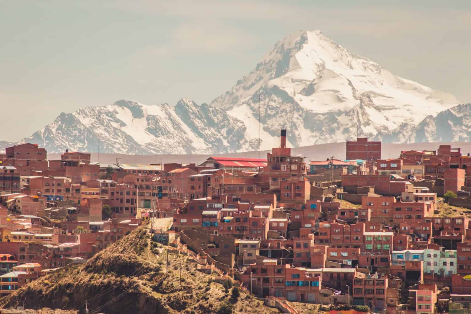 Huayna Potosí Mountain in the background of a brick houses in La Paz, Bolivia.